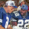 Dallas Cowboys Troy Aikman and Emmitt Smith talk while seated on the sidelines of a game against the Miami Dolphins at Pro Player Stadium in Miami, Fla.