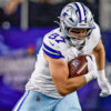 Dallas Cowboys tight end Jake Ferguson (87) catches a pass for a first down as Minnesota Vikings cornerback Byron Murphy Jr. (7) tries to tackle him during a game at AT&T Stadium in Arlington, Texas