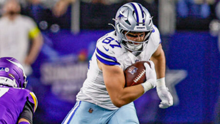 Dallas Cowboys tight end Jake Ferguson (87) catches a pass for a first down as Minnesota Vikings cornerback Byron Murphy Jr. (7) tries to tackle him during a game at AT&T Stadium in Arlington, Texas